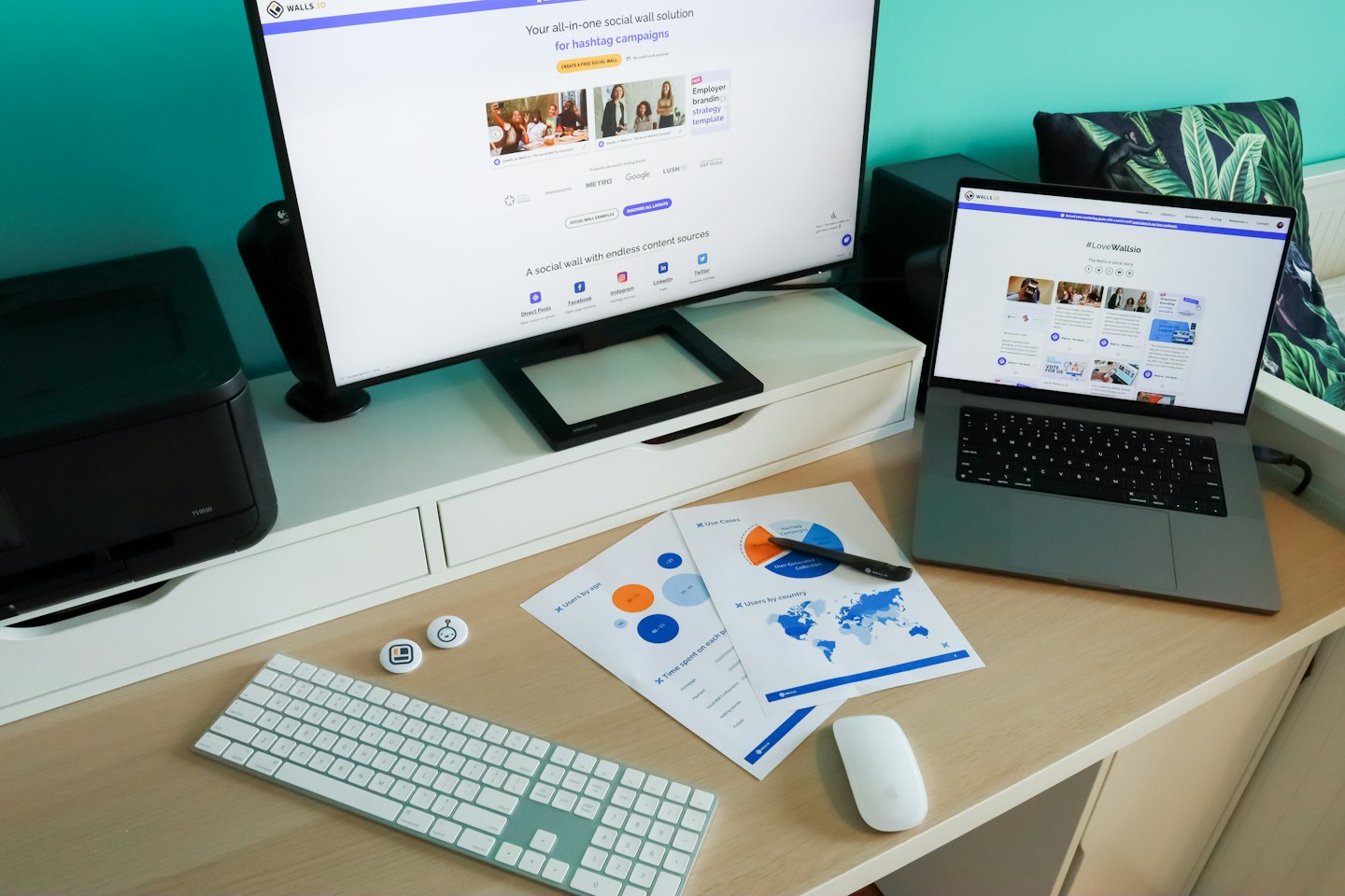 Bureau in thuiskantoor met monitoren, rapporten en printer.